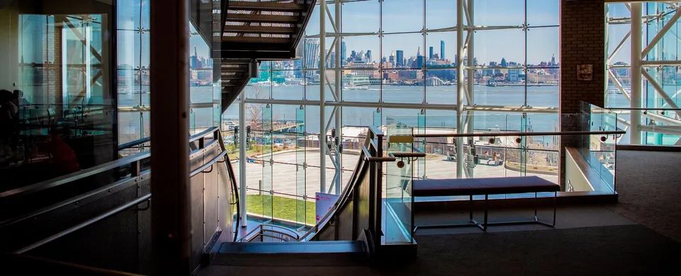 Babbio Center atrium, glass wall onto the Hudson and the Manhattan skyline